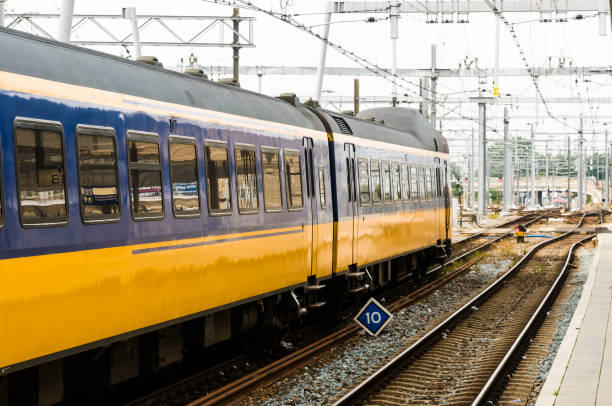 istock Blue and yellow train leaving Utrecht Centraal Station 1165878520