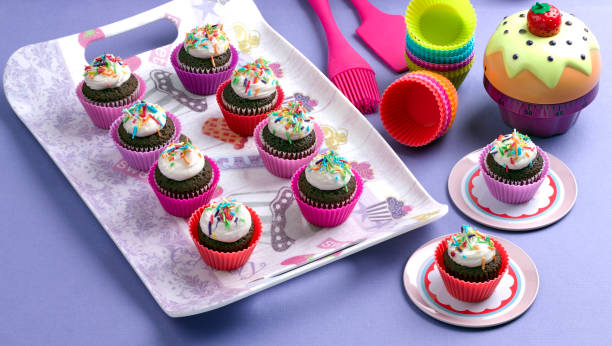 istock Colorful chocolate cupcakes, brownie on purple background 1165882282