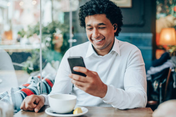 istock Portrait of modern man with Wireless earbuds in a cafe 1165882376