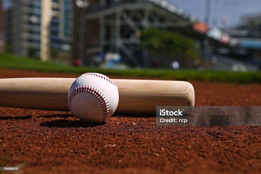Baseball and Bat Baseball and bat on a ball field Baseball Spring Training Stock Photo
