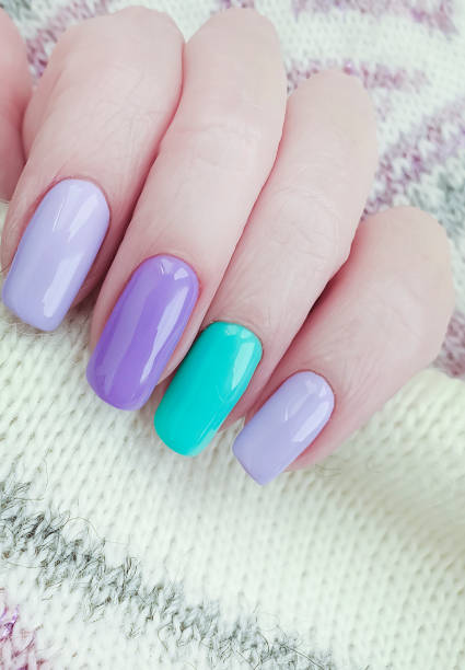 istock female hand beautiful manicure sweater 1165887758