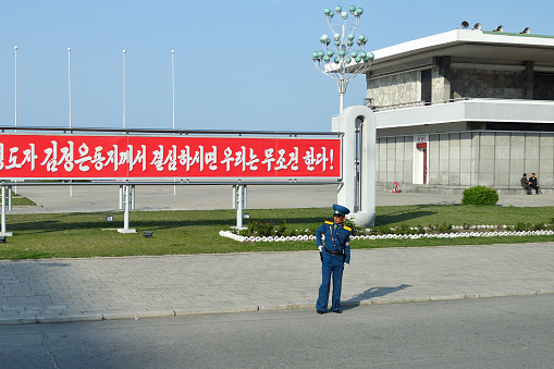 Wonsan, North Korea - May 3, 2019: Traffic policeman regulates traffic on the city street