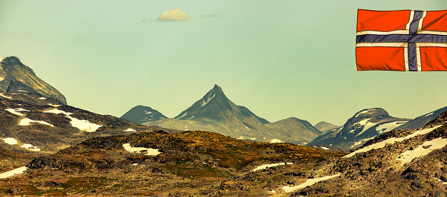 Mountain panorama with summit in Jotunheimen with Norwegian flag
