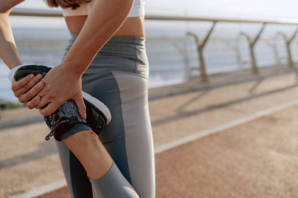 istock Young lady doing legs stretching exercises outdoor 1165900594