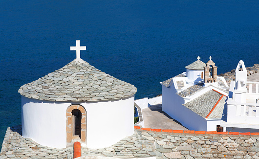 White church and monastery of Evangelistria, the Virgin Mary and Panagitsa Tower in Chora Town, the capital of Scopelos island, Northen Sporades, Greece. It was built in 1712.