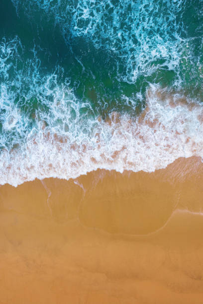 istock Aerial view of Blue ocean wave on sand beach. 1165902821