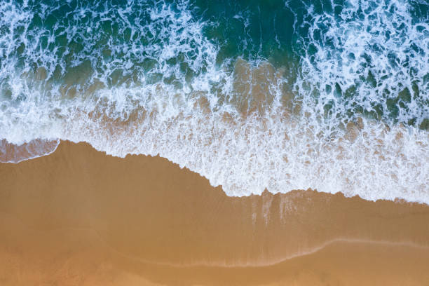 istock Aerial view of Blue ocean wave on sand beach. 1165902836