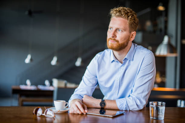 istock Serious young businessman contemplating while taking a break from work in coffee shop. 1165905532