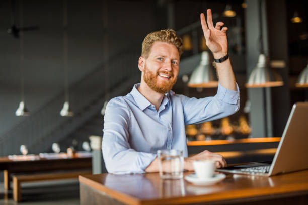 istock Young man working in coffee shop and calling a waiter. 1165905533