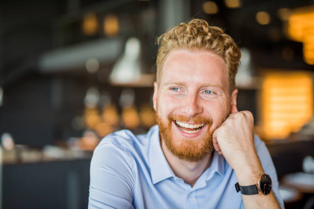 istock Charming young man relaxing in a coffee shop portrait. 1165905587