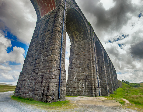 Closeup view of a large old Victorian railway viaduct across valley in rural countryside scenery
