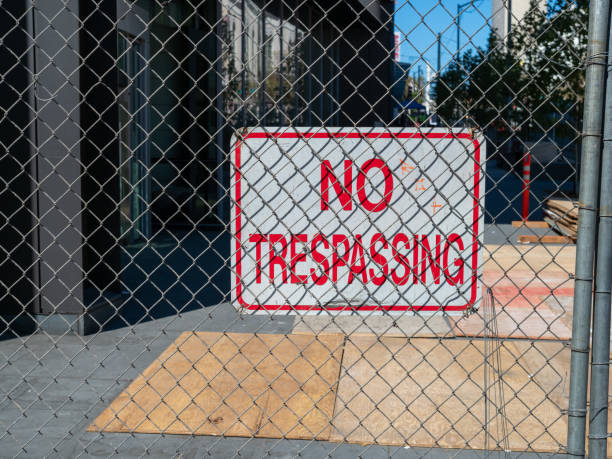 istock No trespassing sign behind chain link fence blocking off urban construction zone 1165906340