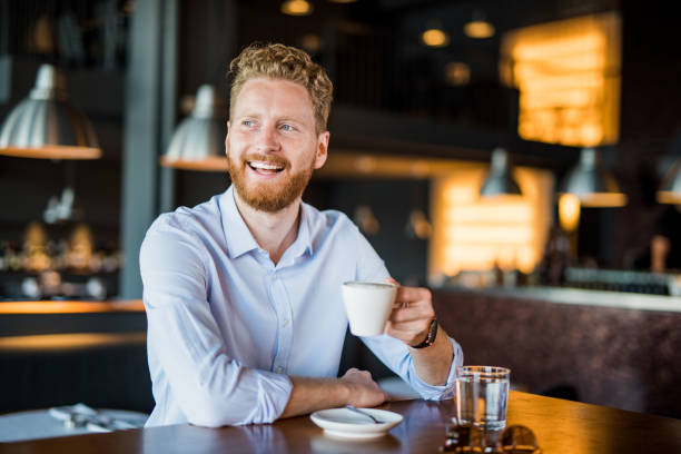istock Happy young man enjoying a coffee break. 1165906672