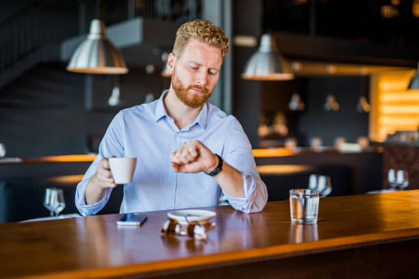 istock Young man relaxing on a coffee break and checking time. 1165906681