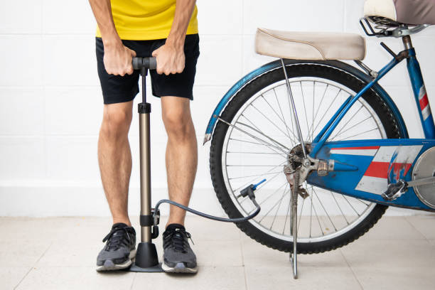 Man inflates the bicycle tire. Man inflates the bicycle tire. inflating stock pictures, royalty-free photos & images