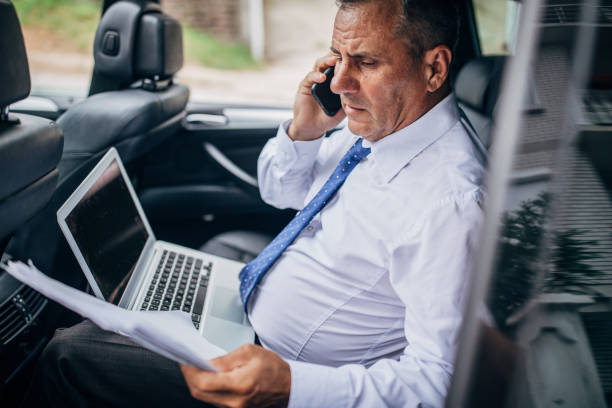 istock Elderly business man in a car 1165908149