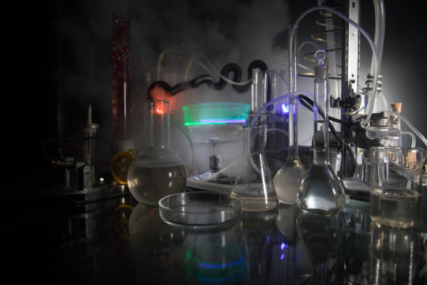istock Pharmacy and chemistry theme. Test glass flask with solution in research laboratory. Science and medical background. Laboratory test tubes on dark toned background 1165911834