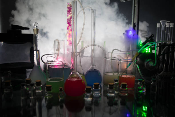 istock Pharmacy and chemistry theme. Test glass flask with solution in research laboratory. Science and medical background. Laboratory test tubes on dark toned background 1165911843