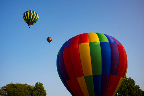 35th annual Spiedie Fest and Balloon Rally Expo, Inc. Festival goers watch hot air balloons take to flight early Saturday morning, August 3, 2019 at the second day of the 35th annual Spiedie Fest and Balloon Rally Expo, Inc. in Binghamton, New York, USA. binghamton ny stock pictures, royalty-free photos & images