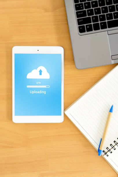 istock top view of business workspace to cloud uploading , notebook and female hands typing on keyboard 1165912337