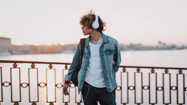 istock Calm young man standing on the bridge 1165913661
