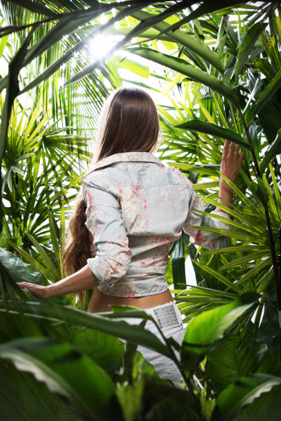 portrait of nice young woman is hanging in tropical jungle