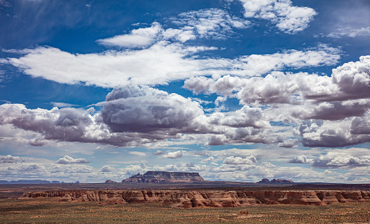 Desert landscape, US. Red sandstone rock formations, blue sky with clouds, spring day in southwestern America