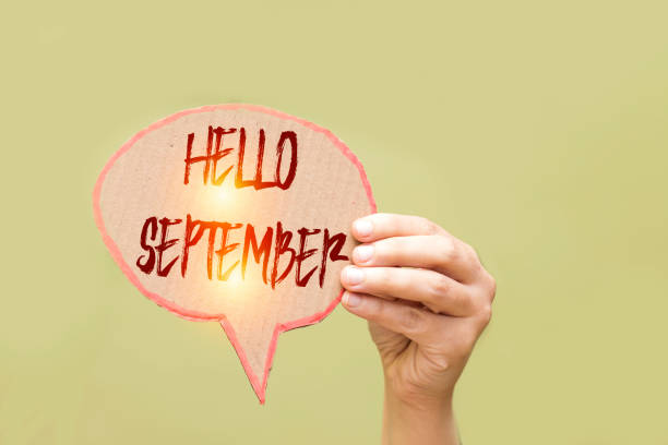 istock women hand holding bubble speech card with hello September 1165920015