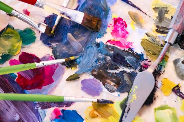 istock artists palette with paints and brushes 1165920732