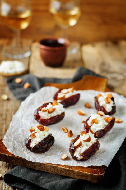istock Almond and goat cheese stuffed dates with glasses of wine 1165925021
