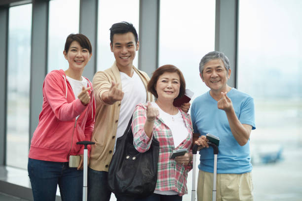 istock Smiling Mixed Age Asian Vacationers Gesturing Love 1165925116