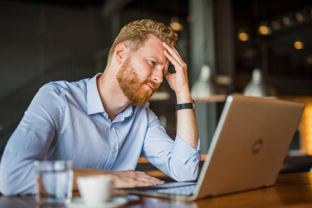 istock Frustrated young man working on laptop and feeling a headache. 1165926030