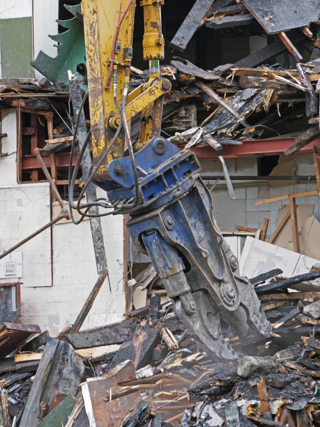 istock a large excavator demolition claw removing debris and rubble from a wrecked building destroyed by fire 1165928132