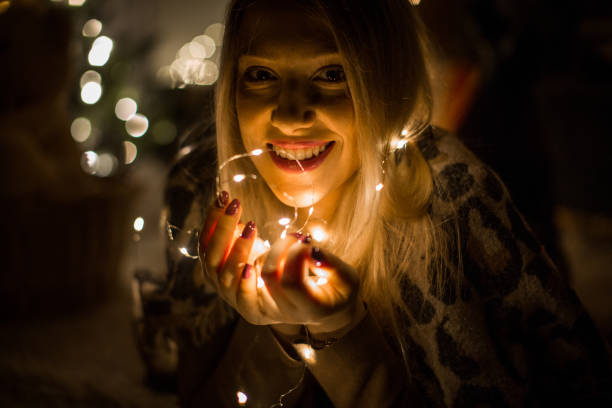 istock Playful girl with lights 1165930499