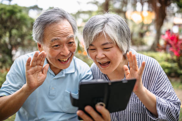 istock Senior couple doing video call with phone 1165931659