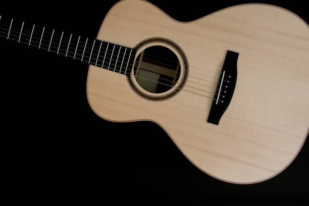 istock Acoustic guitar music close-up flat-lay image on black background 1165933397