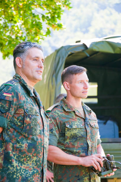istock Two army officers observe a military exercise 1165934293