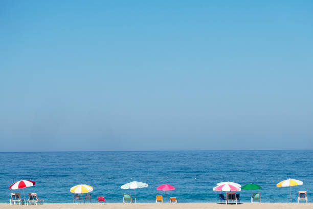 istock Lounge chair with umbrella on beach. 1165937239