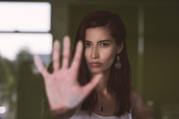 istock Young attractive woman watching out the window with reflections 1165939117