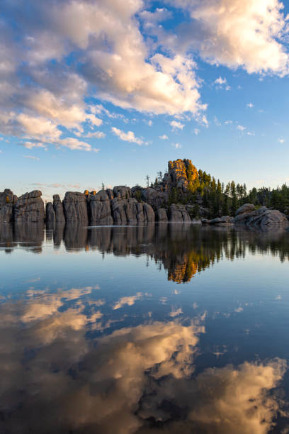 First Light, Sylvan Lake Sunrise strikes the tallest formation to welcome morning on Sylvan Lake, Custer State Park, South Dakota. custer state park stock pictures, royalty-free photos & images