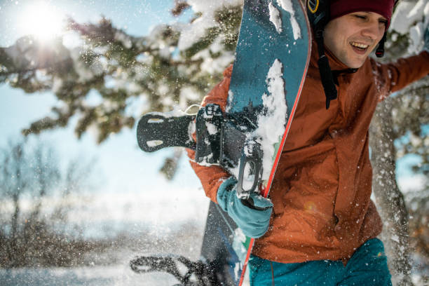 istock Snowboarder is moving through the forest 1165940589