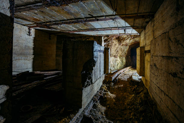 istock Dark dirty abandoned uranium mine with rusty remnants of railway 1165946379