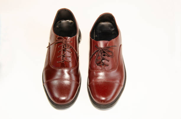 istock Brown leather shoes photos Put on a white background 1165946401