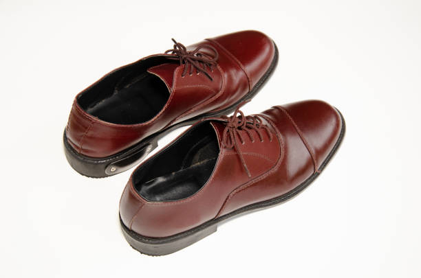 istock Brown leather shoes photos Put on a white background 1165946408