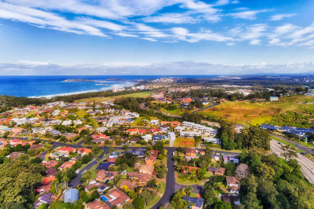 D Coffs Harbour Banana 2 sea Coffs Harbour town streets, roads and suburbs on Australian pacific coast at the centre of banana industry with famous The Big Banana - aerial view towards distant town marina, port and Muttonbird island. coffs harbour stock pictures, royalty-free photos & images