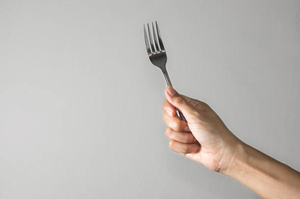 istock Metal fork in woman hand. 1165956592