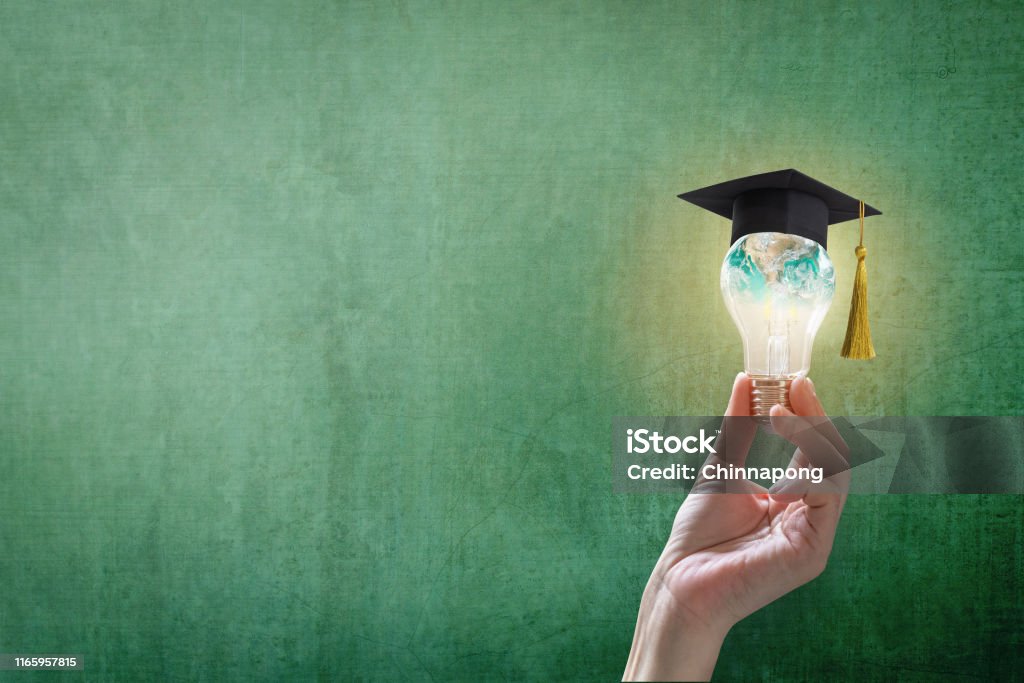 Innovative learning, creative educational study concept for graduation and school student success with world lightbulb on teacher chalkboard Education Stock Photo