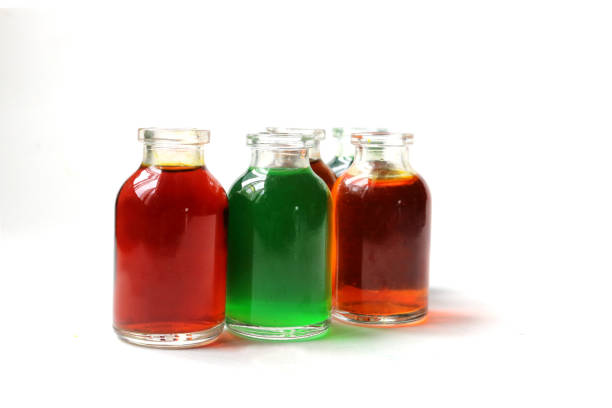 color liquid in glass bottle on white background