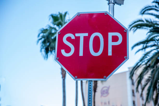 istock Stop sign against blue sky background. Sunny spring day 1165961931