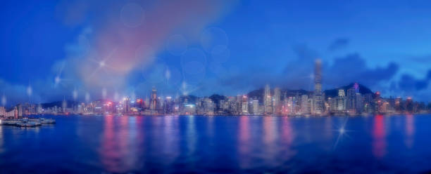istock Abstract bokeh light with Hong Kong City night view background; Double Exposure 1165963978